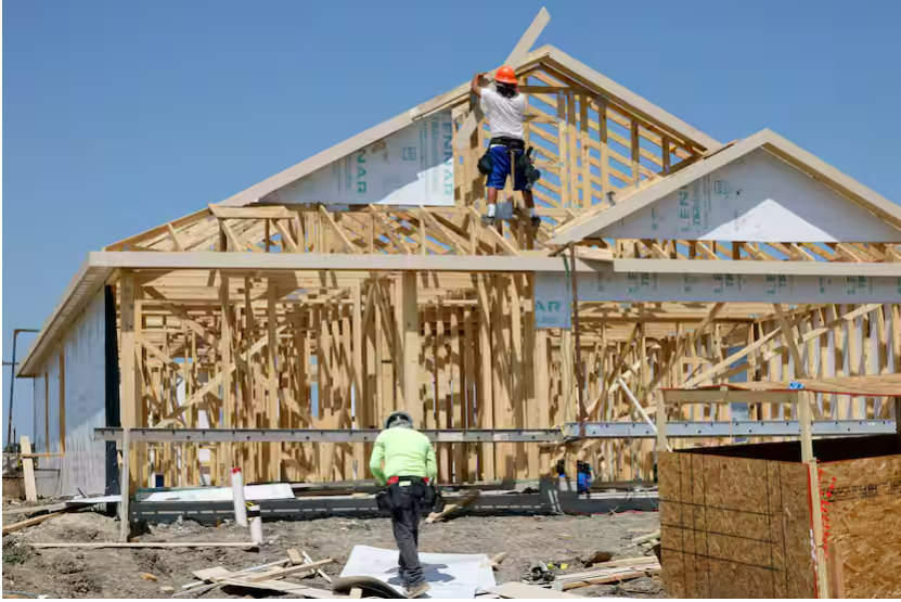 Construction workers framing a house